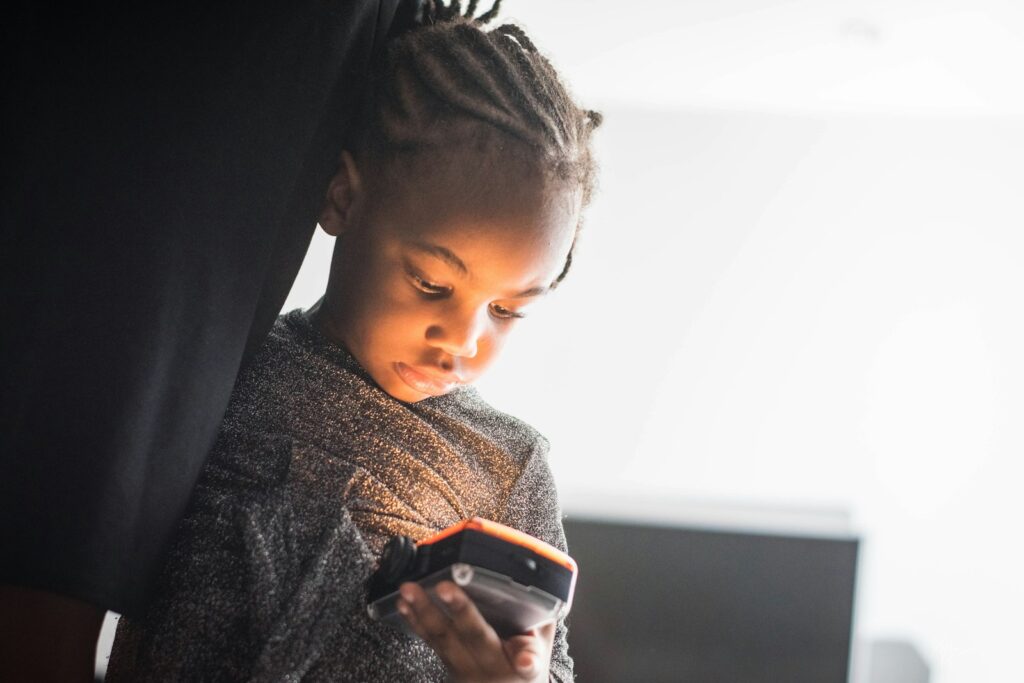 A child using a phone, one of the top topics in what parents are searching